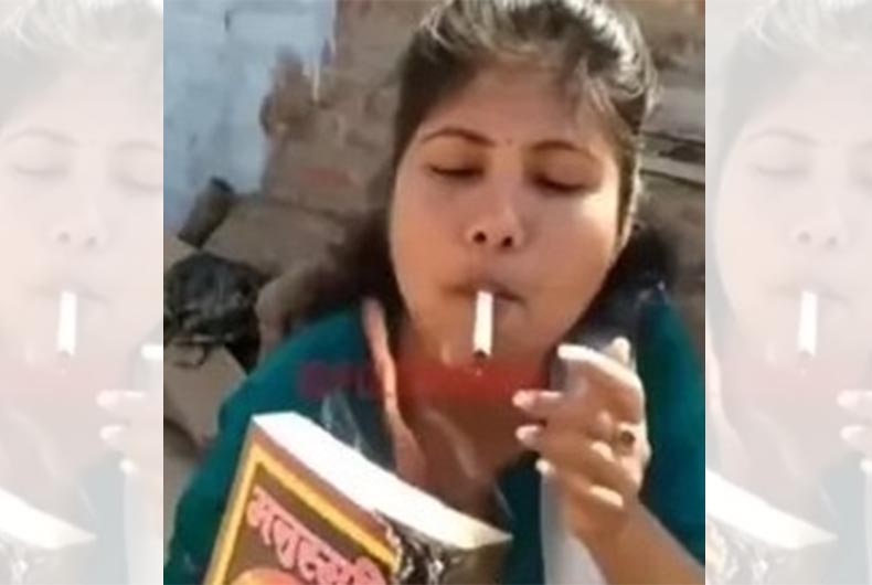 Watch: Woman torches Manusmriti; Lights cigarette, cooks chicken with it