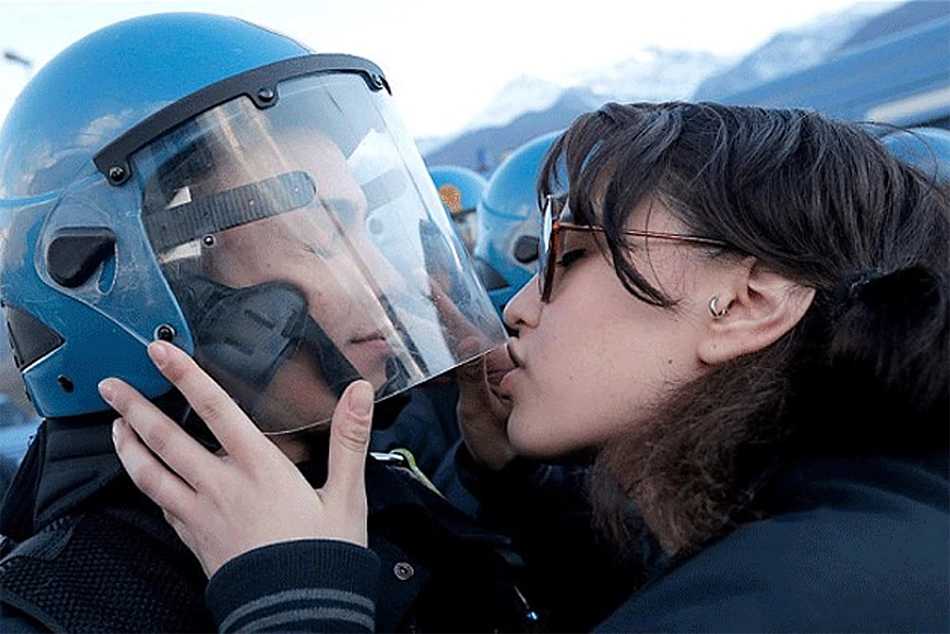 Watch: Woman Kisses, Wink at Policeman during Anti-Israel Protest in Spain