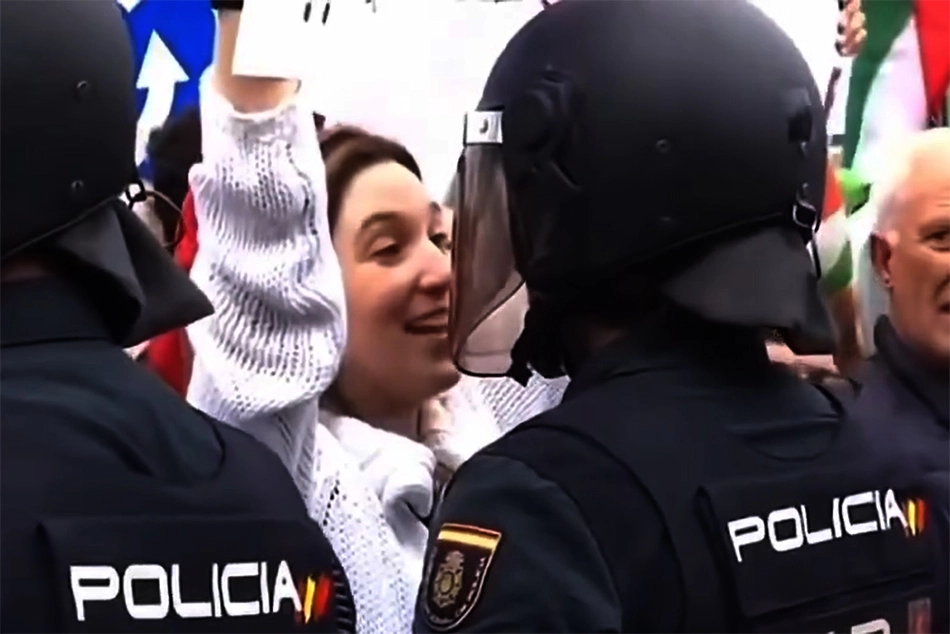 Watch: Woman Kisses, Wink at Policeman during Anti-Israel Protest in Spain